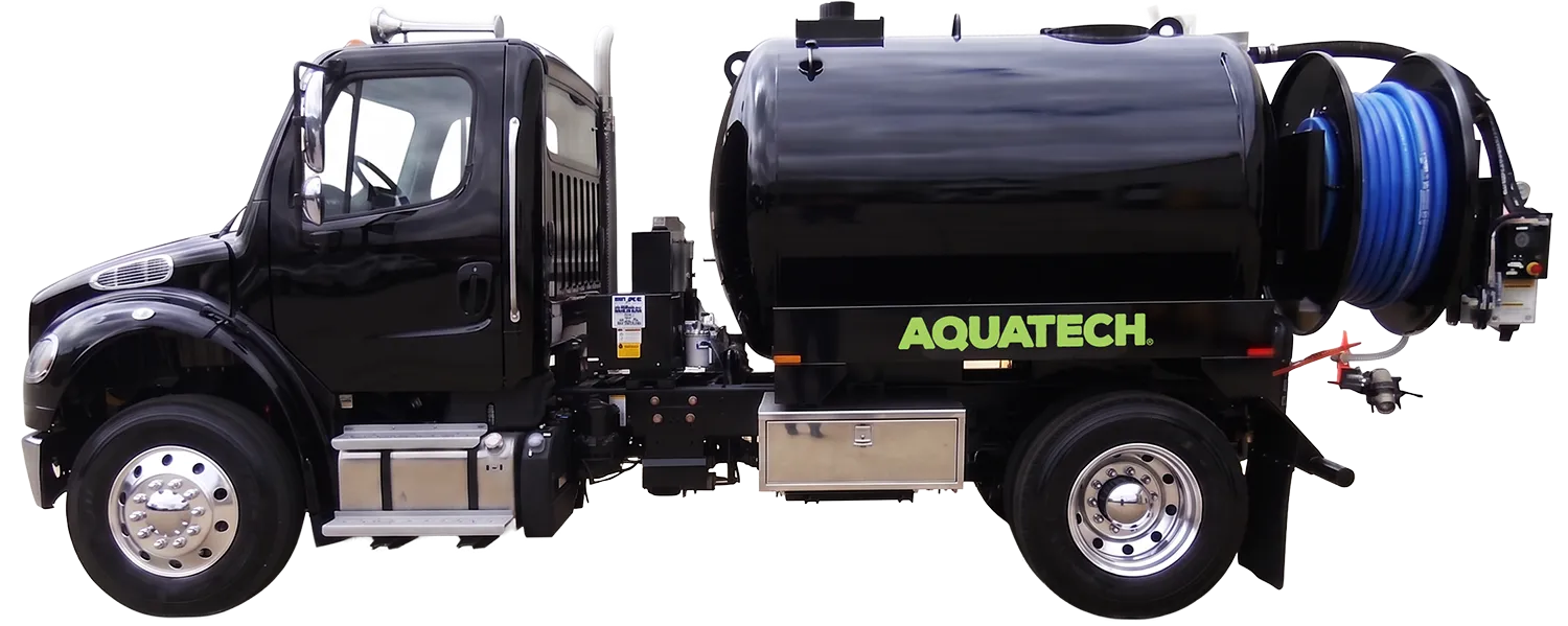 Aquatech combination sewer jetter truck with black tank and blue hose spool, designed for sewer cleaning operations.
